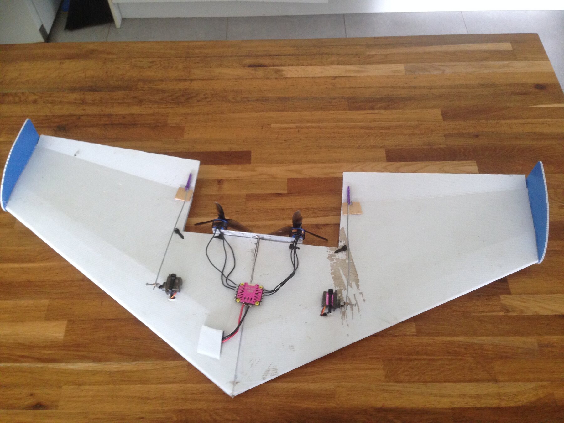 The 2022 Vera speed wing opened on a workbench, showing its pink ESC and electronics